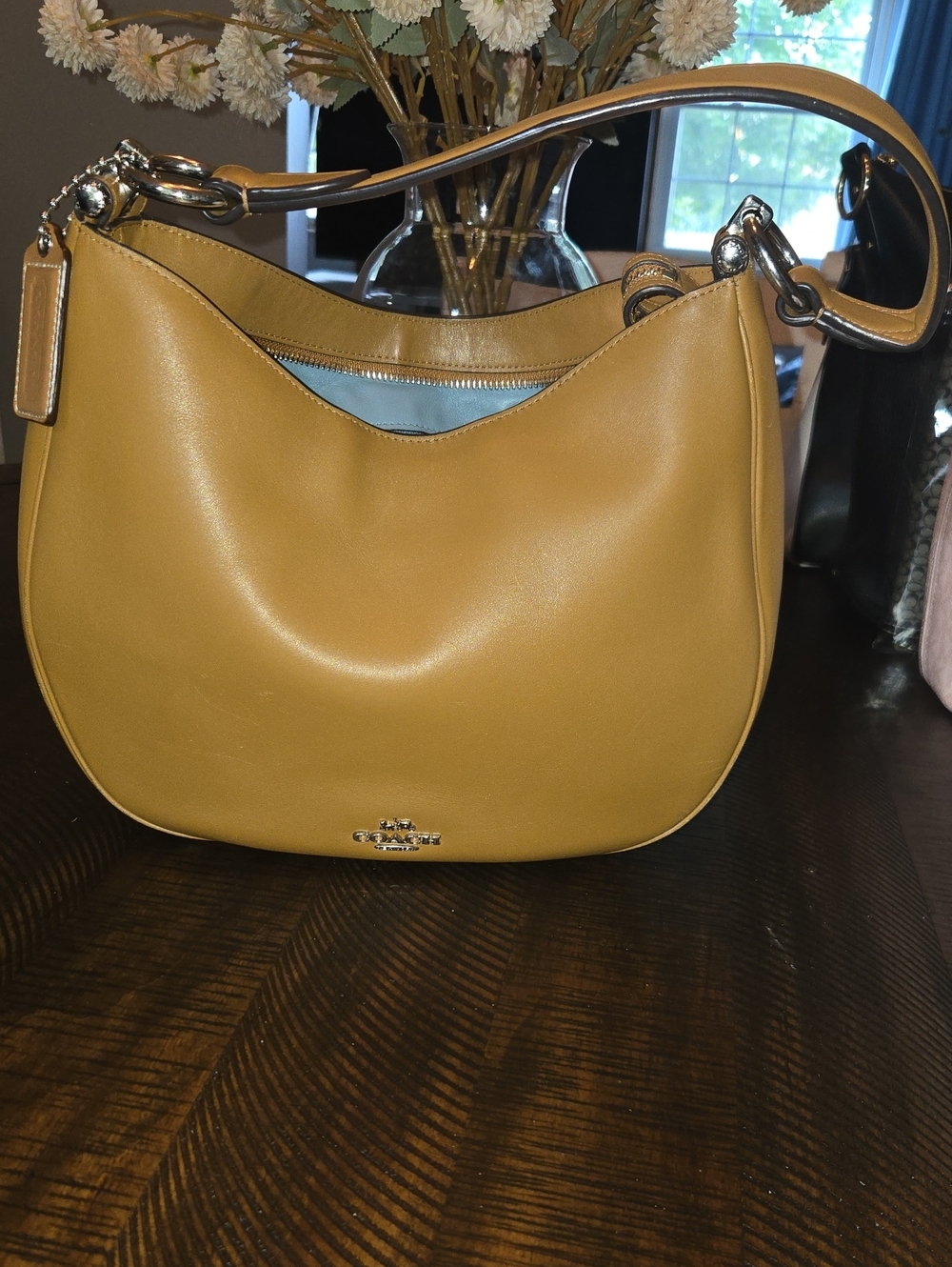Coach Pebble Leather Hobo Shoulder Bag. This purse is the Medium Nomad In Brown